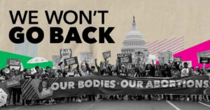 Graphic entitled We Won't Go Back showing photo of street crowd protest holding large horizontal banner reading Our Bodies - Our Abortions