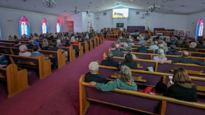 Photo of the attendees at Mt. Zion First African Baptist Church watching "Repairing the World" screening from the pews