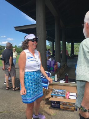 Photo of Amy Laufer wearing a white blouse and blue skirt and sunglasses at the picnic