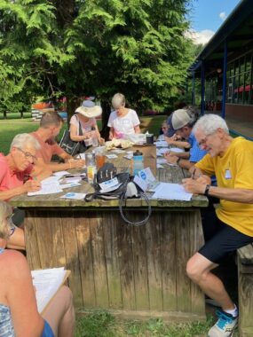 Photo of volunteers writing postcards at "Turn Out the Vote Thursdays” August 24, 2023