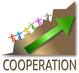 Graphic labeled "Cooperation"  showing six stylized stick figures, each a different bright color, holding hands to help each other up a jagged difficult-to-climb hillside. A green arrow points up the hill.