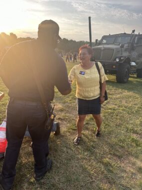 Gloria Witt campaigns July 3, 2024, shaking hands with a person in Bedford, VA